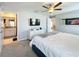 This bedroom features a ceiling fan, TV, ensuite bathroom, and a window at 12764 Weston Oaks Ln, Riverview, FL 33579