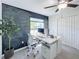 Office features a large desk, stylish decor, and inviting chalkboard wall for creativity at 12764 Weston Oaks Ln, Riverview, FL 33579
