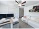 Bright office space features modern white desk, shelving, and comfortable seating area under ceiling fan at 12764 Weston Oaks Ln, Riverview, FL 33579