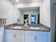 Double sink bathroom with granite countertop and modern white cabinets at 12764 Weston Oaks Ln, Riverview, FL 33579