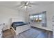 Bright bedroom with a white sleigh bed, nightstands, and a ceiling fan at 5735 Shorebird Br, Land O Lakes, FL 34638