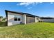 Large backyard with green grass, a screened patio and exterior of a single Gathering home at 5735 Shorebird Br, Land O Lakes, FL 34638