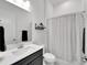 Clean bathroom with a shower/tub combo, vanity with sink, and toilet at 5735 Shorebird Br, Land O Lakes, FL 34638