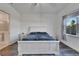 Spacious bedroom with white sleigh bed and en-suite bathroom access at 5735 Shorebird Br, Land O Lakes, FL 34638