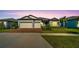 Two-story home with two-car garage, landscaping, and front yard at 5735 Shorebird Br, Land O Lakes, FL 34638