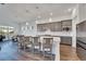 Modern kitchen featuring gray cabinets, quartz countertops, and stainless steel appliances at 5735 Shorebird Br, Land O Lakes, FL 34638