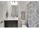 Bathroom with vanity, toilet, and shower with patterned curtain at 5735 Shorebird Br, Land O Lakes, FL 34638