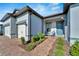 House exterior with a covered porch, two-car garage and landscaping at 5735 Shorebird Br, Land O Lakes, FL 34638