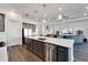Open concept kitchen with island, stainless steel appliances, and view of living area at 5735 Shorebird Br, Land O Lakes, FL 34638