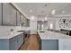 Modern kitchen with gray cabinets, white quartz countertops, and stainless steel appliances at 5735 Shorebird Br, Land O Lakes, FL 34638