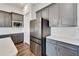 Modern kitchen features stainless steel appliances and gray cabinets at 5735 Shorebird Br, Land O Lakes, FL 34638
