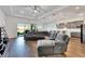 Spacious living room showcasing a sectional sofa and access to backyard at 5735 Shorebird Br, Land O Lakes, FL 34638