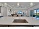 Kitchen island with sink, providing a view of the living room and backyard at 5735 Shorebird Br, Land O Lakes, FL 34638