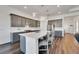 Modern kitchen with gray cabinets, white quartz countertops, and stainless steel appliances at 5735 Shorebird Br, Land O Lakes, FL 34638