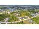 Aerial view of a home nestled among lush greenery and neighboring houses near the water at 8489 Topeka Cir, Port Charlotte, FL 33981