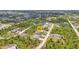 Aerial view of a home with lush greenery and neighboring houses in a residential area at 8489 Topeka Cir, Port Charlotte, FL 33981