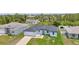Aerial view of a new home in a tropical neighborhood with a manicured lawn at 8489 Topeka Cir, Port Charlotte, FL 33981