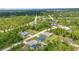 An aerial view shows this home surrounded by trees at 8489 Topeka Cir, Port Charlotte, FL 33981