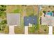 An aerial view of the home featuring a driveway and landscaped yard at 8489 Topeka Cir, Port Charlotte, FL 33981
