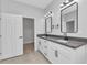 This is a bright bathroom that features double sinks, square mirrors, and a door to a closet at 8489 Topeka Cir, Port Charlotte, FL 33981