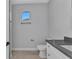 Modern bathroom featuring sleek vanity with stone countertop and neutral tile floors at 8489 Topeka Cir, Port Charlotte, FL 33981