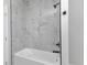 Elegant bathroom showcasing a tiled shower and tub combination with modern fixtures at 8489 Topeka Cir, Port Charlotte, FL 33981