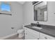 Bathroom featuring modern vanity, black faucet, and walk-in shower with gray backsplash at 8489 Topeka Cir, Port Charlotte, FL 33981
