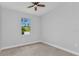 This bright bedroom features neutral walls, tile floors and a window view of outdoors at 8489 Topeka Cir, Port Charlotte, FL 33981