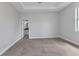 This spacious bedroom features neutral walls, tile floors, and an ensuite bathroom at 8489 Topeka Cir, Port Charlotte, FL 33981