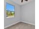 Bright bedroom with neutral paint and large window overlooking the greenery at 8489 Topeka Cir, Port Charlotte, FL 33981