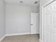 Spacious bedroom features neutral walls and tile floors with closet and doorways at 8489 Topeka Cir, Port Charlotte, FL 33981
