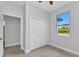 Well-lit bedroom features a closet, and view of outdoors through the window at 8489 Topeka Cir, Port Charlotte, FL 33981