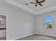 Bedroom boasts tray ceiling, tile floors, neutral walls, and an attached bath at 8489 Topeka Cir, Port Charlotte, FL 33981