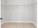 This walk-in closet has a wire shelving system and tan tile flooring at 8489 Topeka Cir, Port Charlotte, FL 33981