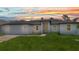 Charming single-story home with a brick driveway and lush green lawn at sunset at 8489 Topeka Cir, Port Charlotte, FL 33981