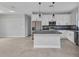 Bright kitchen featuring modern appliances, white cabinets, and a center island with gray countertops at 8489 Topeka Cir, Port Charlotte, FL 33981