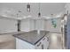Open floor plan with a large kitchen island, pendant lighting, and view into the living room at 8489 Topeka Cir, Port Charlotte, FL 33981
