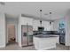 Modern kitchen boasting stainless steel appliances, white cabinets, gray countertops, and a kitchen island at 8489 Topeka Cir, Port Charlotte, FL 33981