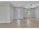 Bright living room featuring a tile floor, modern light fixture, recessed ceiling, and a glass panel door at 8489 Topeka Cir, Port Charlotte, FL 33981