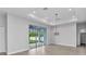 Open living room with recessed lighting, ceiling fan, and sliding glass doors leading to the outdoor patio and backyard at 8489 Topeka Cir, Port Charlotte, FL 33981