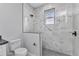 The walk-in shower features attractive modern gray and white tiling, and a window for natural light at 8489 Topeka Cir, Port Charlotte, FL 33981