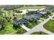 Aerial view of a single-Gathering home on a tree-lined street at 39 Tee View Pl, Rotonda West, FL 33947