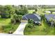 Aerial view of house, yard, and surrounding area at 39 Tee View Pl, Rotonda West, FL 33947