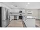 Modern kitchen with white cabinets, stainless steel appliances, and granite countertops at 304 W Fern St, Tampa, FL 33604