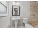 Clean bathroom with a pedestal sink, toilet and shower at 304 W Fern St, Tampa, FL 33604