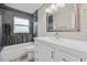 Updated bathroom with white vanity and grey tile at 304 W Fern St, Tampa, FL 33604