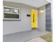 Inviting entryway with a bright yellow door and modern design at 304 W Fern St, Tampa, FL 33604