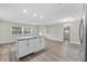 Remodeled kitchen features white cabinets, granite countertops, and stainless steel appliances at 304 W Fern St, Tampa, FL 33604
