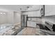 Modern kitchen with white cabinets, stainless steel appliances, and granite countertops at 304 W Fern St, Tampa, FL 33604