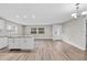Open concept kitchen with island, white cabinets, and luxury vinyl plank flooring at 304 W Fern St, Tampa, FL 33604